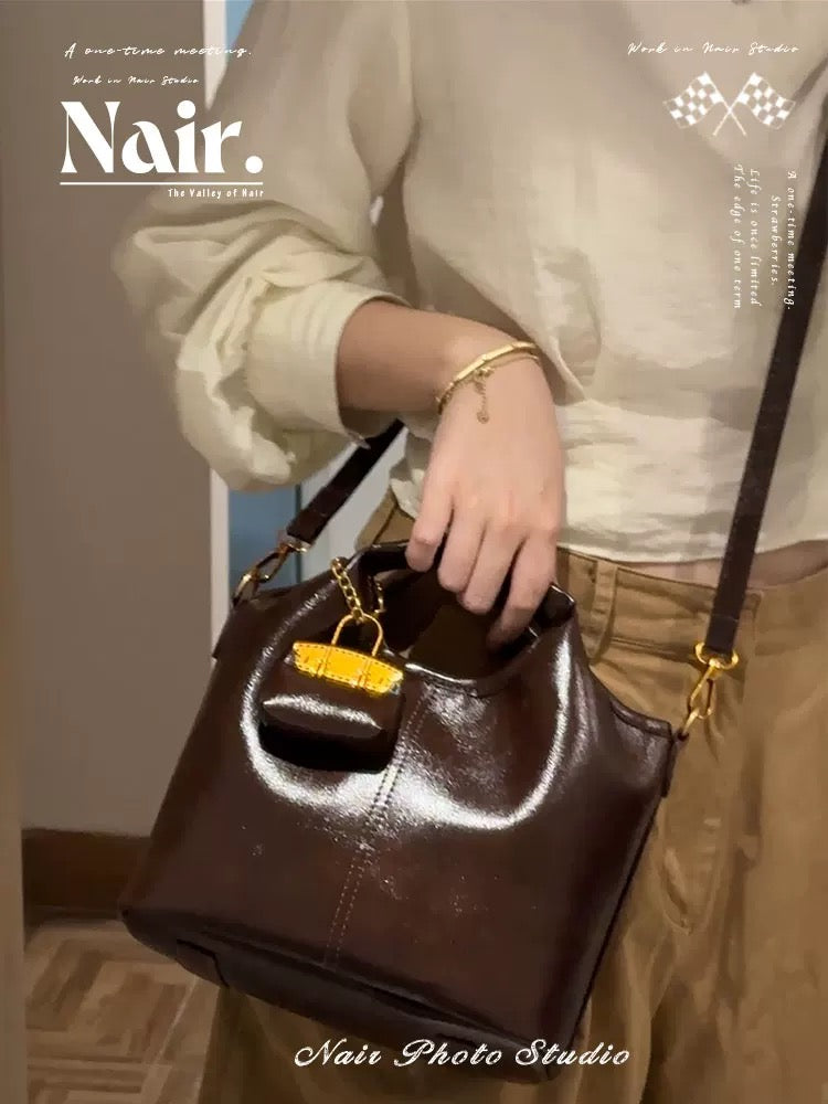 Hand-held bucket bag with small bag hanger